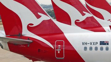 Baggage is loaded onto a Qantas jet at Melbourne Tullamarine Airport. 