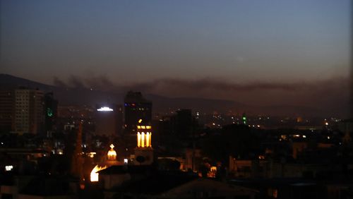 Smoke rises over Damascus following the airstrikes. (AAP)