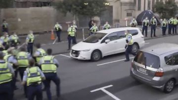 A person has been arrested after a car was driven at police at a protest in New Zealand.