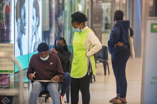 People lineup to get vaccinated at a shopping mall in Johannesburg, South Africa, Friday Nov. 26, 2021.