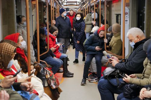 People ride a subway carriage as some of them read on their smartphones  in Moscow, Russia, Thursday, Feb. 24, 2022. (AP Photo/Alexander Zemlianichenko Jr)