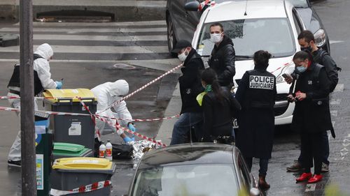 Police officers gather in the area of a knife attack near the former offices of satirical newspaper Charlie Hebdo, Friday September 25, 2020 in Paris.
