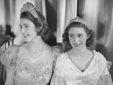 Princess Elizabeth (Queen Elizabeth II) and Princess Margaret (1930-2002), both dressed in elaborate gowns, pictured during a royal pantomime production of 'Old Mother Red Riding Boots' at Windsor Castle, Berkshire, Great Britain, 22 December 1944. (Photo by Lisa Sheridan/Studio Lisa/Getty Images)