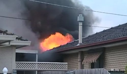 Flames licked the roof of the Sunshine West home. (9NEWS)