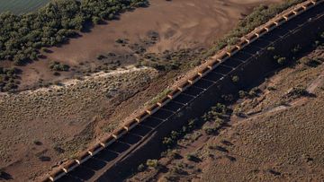 A loaded Rio Tinto iron ore train arrives at their port facility on the Murujuga (Burrup) Peninsula in the Pilbara region of Western Australia.