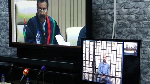 Saif al-Islam Gaddafi (R) appears via video-link up in a Libyan court last year. (AFP)