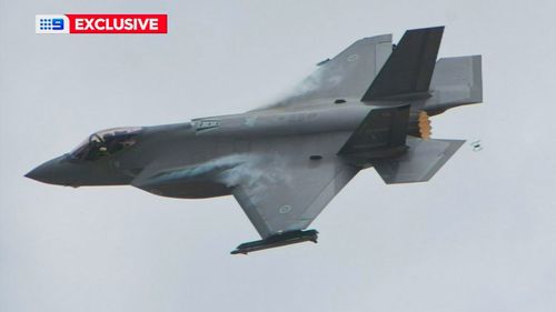 A drone was flying dangerously close to a fighter jet during an air show at the Adelaide 500.