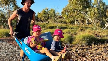 James Brougham is running 500km this month while pushing his daughters Halle and Isla in a wheelbarrow.