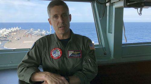 Rear Admiral Steve Koehler, commander CSG-9 of the U.S. aircraft carrier Theodore Roosevelt, briefs top Philippine generals in international waters off South China Sea.