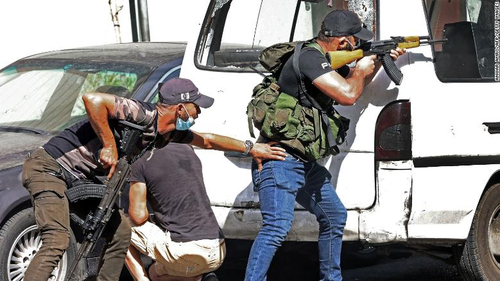 Fighters take aim during armed clashes in the Tayouneh neighborhood of Beirut on October 14.