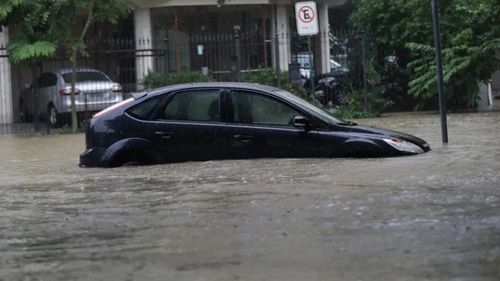 An abandoned vehicle sits in floodwaters. The mayor is calling for hundreds of millions of Brazilian reals to fund better flood preparedness. (Silvia Izquierdo/Associated Press)