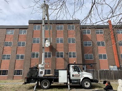 Nick was launched into the air to see his wife on a cherry picker with the help of his son Chris.