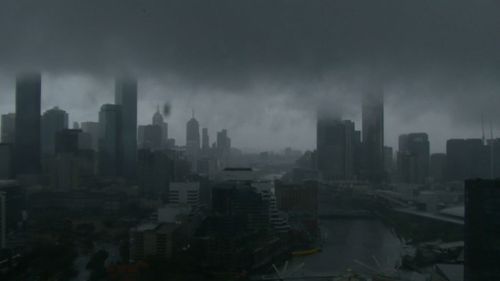 Dark skies shrouded the CBD as heavy rain closed in. (9NEWS) 