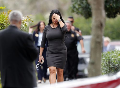 A mourner holds her head n disbelief after Alaina Petty's funeral. (AAP)