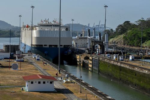 A ship is guided through the Panama Canal's Miraflores locks near Panama City in April 2023