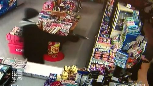 In CCTV video from inside the store the masked man can be seen entering, armed with what appears to be a gun.
