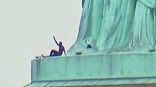 The protester climbed the base of the Statue of Liberty during Independence Day celebrations. Picture: Supplied