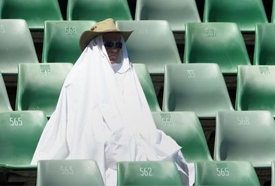 This fan went to extreme measures to keep the sun off him. (Getty)