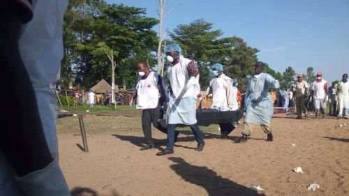 Hundreds of solemn people watched as body after body was pulled from a capsized ferry that Tanzanian authorities said was badly overcrowded and upended in the final stretch before reaching shore. 