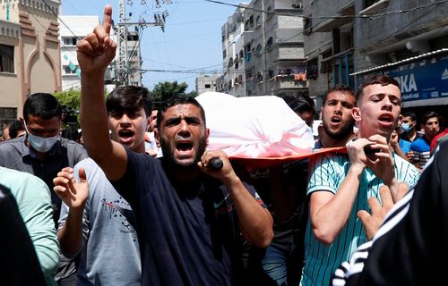 Mourners carry the body of Amira Soboh, and her 19-year-old disabled son Abdelrahman, who were killed in Israeli airstrikes