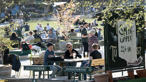 People gather for a drink at an outdoor bar in Stockholm, Sweden, Wednesday April 22, 2020 despite the coronavirus COVID-19 outbreak. (Anders Wiklund/TT via AP)
