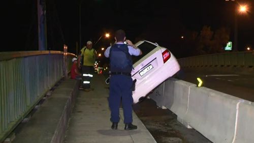 Alleged high-range drink driver strands car on Sydney road barrier