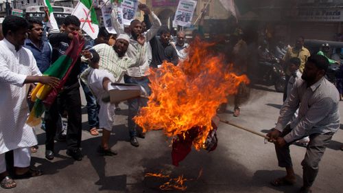 Indian Muslims burn an effigy of Myanmar's radical Buddhist monk Ashin Wirathu during a protest against the persecution of Myanmar's Rohingya Muslim minority. (AAP)