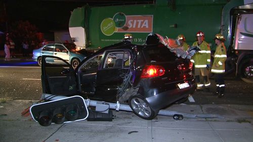 The traffic light pole was flattened and the roof of the Volkswagen ripped off. (9NEWS)