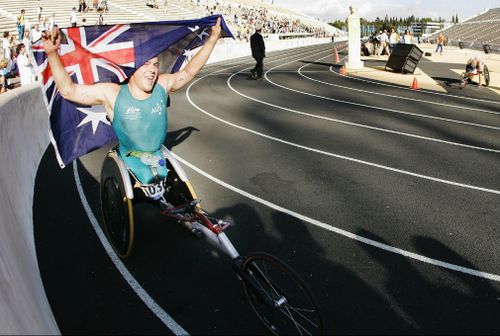 Fearnley pulls the Australian flag over his head after winning the Mens Marathon (T54) at Panathinaiko Stadium during the 2004 Paralympic Games in Athens, Greece. (Getty)