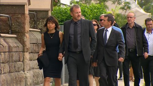 Mourners arrive at the funeral service this morning. (9NEWS)