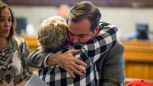 Cincinatti Mayor John Cranley hugs a member of Kyle Plush's family. (AP).