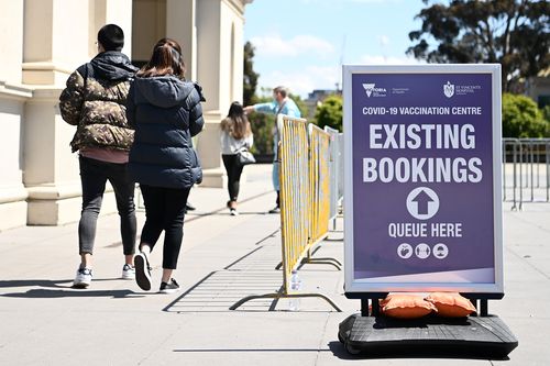 MELBOURNE, AUSTRALIA - OCTOBER 12: People enter the Vaccination Centre at Royal Exhibition Building in Carlton on October 12, 2021 in Melbourne, Australia. Victoria has recorded 1466 new COVID-19 cases and eight deaths in the last 24 hours. The state will reach a vaccination milestone today, with 60% of Victorians over the age of 15 having received two doses of a COVID-19 vaccine. (Photo by Quinn Rooney/Getty Images)