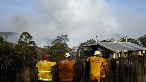 NSW Rural Fire Service crews watch on as the Morton Fire burns in bushland close to homes at Penrose in the NSW Southern Highlands, 165km south of Sydney, Friday, January 10, 2020