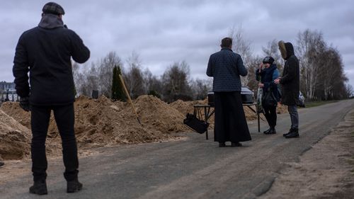 Natalya Verbova, 49, and her son Roman Verbovyi, 23, attend the funeral of her husband Andriy Verbovyi, 55, who was killed by Russian soldiers while serving in Bucha territorial defense, in the outskirts of Kyiv, Ukraine, Wednesday , April 13, 2022.