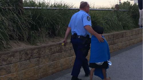 A young boy is assisted by a police officer.
 (9NEWS Illawarra)