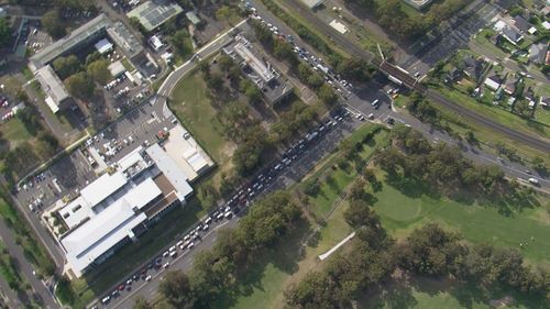 Long lines of cars have been filmed snaking around blocks today as Sydney residents seek PCR tests.
