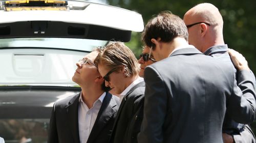 Tori Johnson's loved ones, including partner Thomas Zinn, at his funeral. (AAP)
