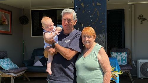 Howard and Shirley Hill with their great-granddaughter outside their beloved Dicky Beach Holiday Park home.