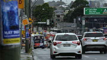 Traffic including buses move along Victoria Road in Sydney, Rozelle, NSW.