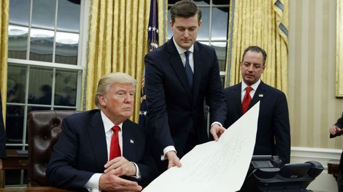 Donald Trump with Rob Porter and former chief-of-staff Reince Priebus. (AAP) 