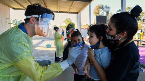 Latisha Carr-McEwan (right) with her children Craig McKellar 4yrs (2nd from right) and Tashayla Eulo 9yrs (right) as they have Covid-19 tests at the Dubbo West walk-in clinic.