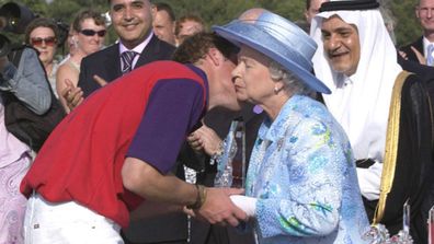 Prince William kissing his grandmother, Queen Elizabeth II, at the Royal Ascot in 2004.