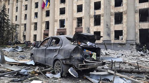 A burnt car is seen in front of a damaged City Hall building, in Kharkiv, Ukraine, Tuesday, March 1, 2022