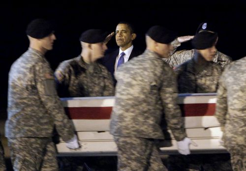In this 2009, file photo, President Barack Obama, centre, salutes as an Army carry team carries the transfer case containing the remains of Sgt. Dale R. Griffin during a transfer event at Dover Air Force Base. (AP)