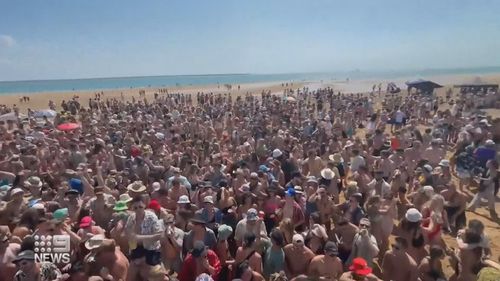 Revellers packed onto a sandbar in Darwin.