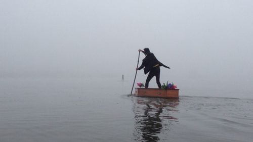 Who is the mystery undertaker paddling the fog shrouded waters of Lake Burley Griffin?