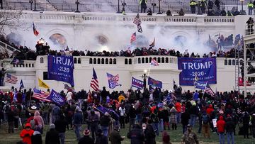 Protesters and rioters surrounding the US Capitol building.