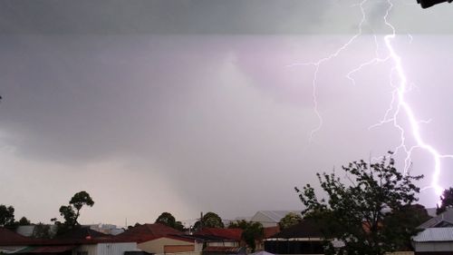 Lightning strikes a home at Chester Hill in Sydney's southwest. (Robbie Iskandar)