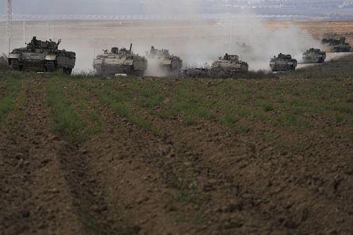 A convoy of Israeli armoured personnel carriers (APC) head towards the Gaza Strip border in southern Israel on Saturday, Oct. 14, 2023.