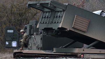 A US soldier sits at a Multiple Launch Rocket System (MLRS) during the demonstration of the reload procedures after an artillery live fire event by the US Army Europe&#x27;s 41st Field Artillery Brigade at the military training area in Grafenwoehr, southern Germany, on March 4, 2020.  